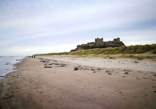 a view of bamburgh castle from the beach