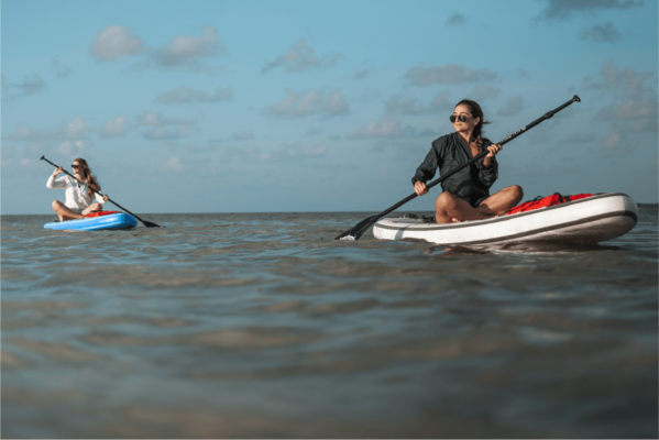 an image of people padding boarding in the sea